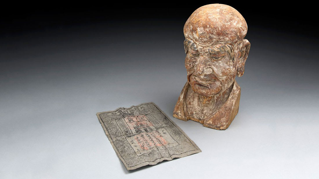 ورقة نقدية عمرها 700 عام في رأس تمثال تاريخي