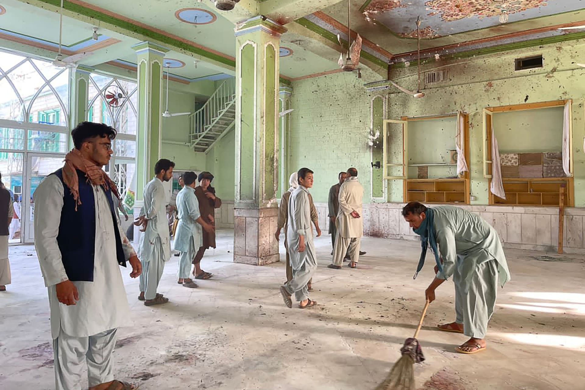 رجال أفغان يتفقدون أضرار الانفجارات داخل مسجد شيعي في قندهار، في 15 أكتوبر/ تشرين الأول 2021