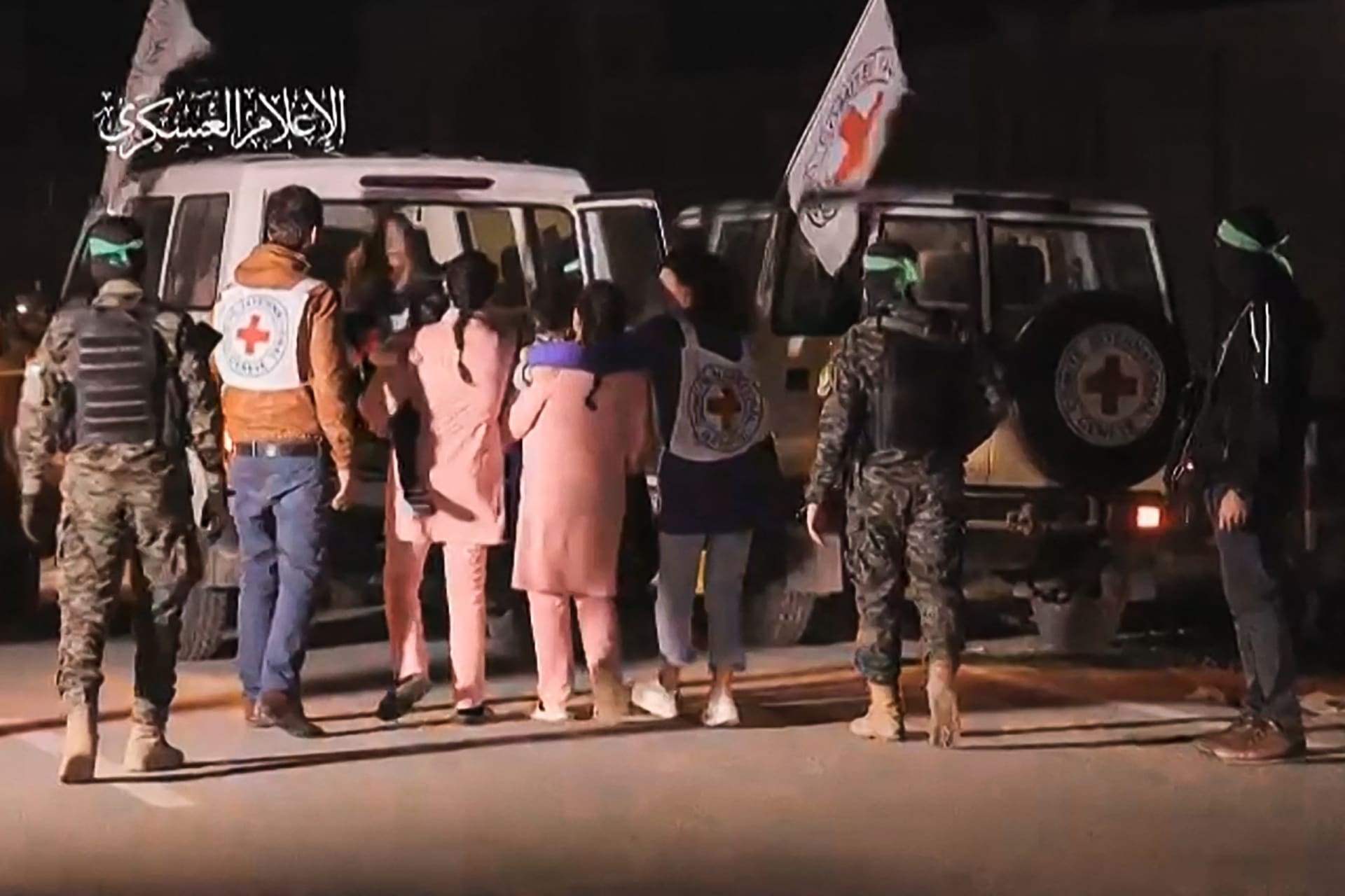  صورة من فيديو نشره المكتب الإعلامي لحماس تظهر مقاتلين من حماس يرافقون رهائن إسرائيليين تم إطلاق سراحهم، الاثنين، إلى مركبة تابعة للصليب الأحمر في قطاع غزة في 27 نوفمبر/ تشرين الثاني 2023.