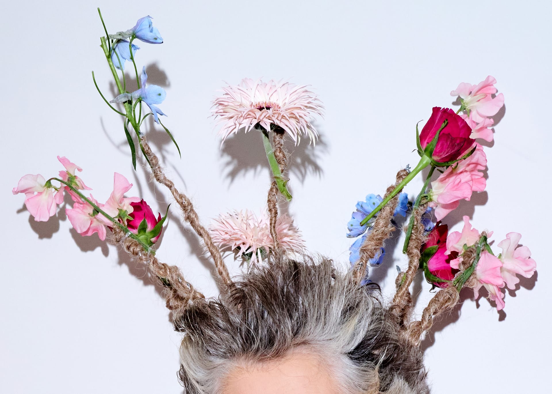 لقطة مقربّة لباقة الأزهار التي وضعتها ليث على رأسها في أسبوع الموضة في لندن. 