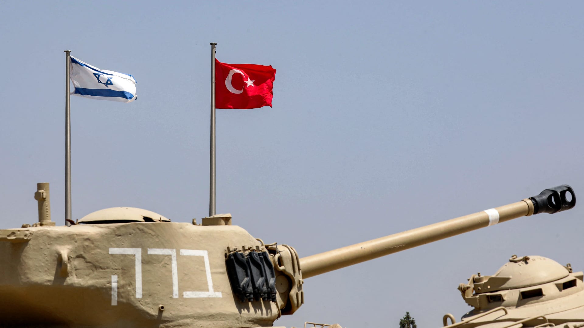 علما إسرائيل وتركيا خلف دبابة قتالية من طراز M4A1 شيرمان معروضة في متحف ياد لا شيريون للدبابات في اللطرون