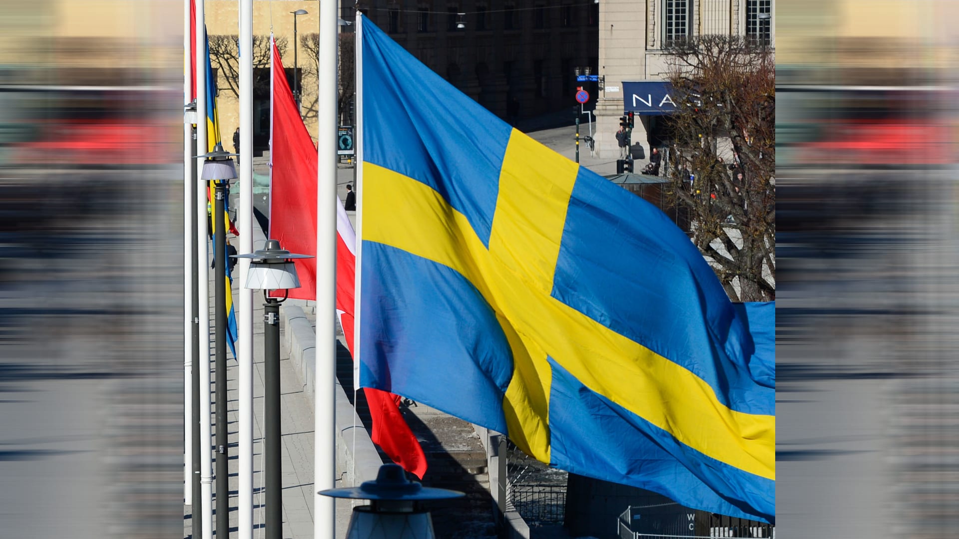 صورة تعبيرية للعلم السويدي وفي الخلف العلم التركي 