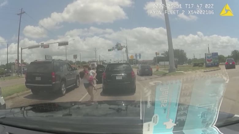 شاهد والدة مذعورة تترجل من سيارتها.. وتجري بابنتها المختنقة نحو دورية شرطة على الطريق