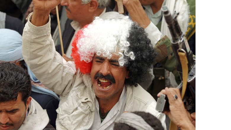 متظاهر في صنعاء يرتدي شعرا مستعارا بلون العلم اليمني في تظاهرة ضد عاصفة الحزم ، 3 مارس/ أبريل 2015