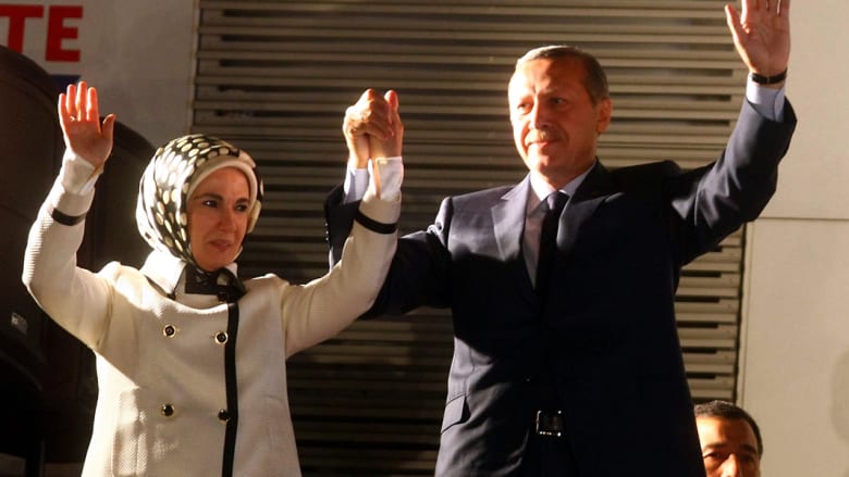 أردوغان برفقة زوجته يحيي مؤيديه في حزب العدالة والتنمية في أنقرة يوم 12 يونيو 2011 بعد انتزاع الحزب الحاكم صاحب الجذور الاسلامية فوزا ساحقا في الانتخابات البرلمانية.