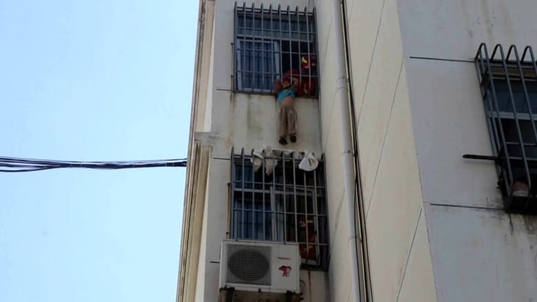 شاهد عملية إنقاذ طفل علق رأسه في سور نافذة بالطابق الخامس